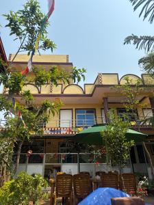 a building with a table and chairs in front of it at Pahuna Ghar Homestay in Tānsen