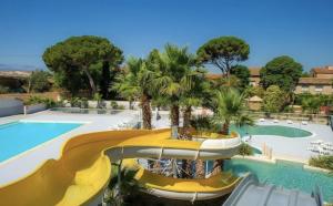 a resort with a slide and a swimming pool at Mobil home 3 chambres - Homair parc des 7 fonts 3 étoiles in Agde