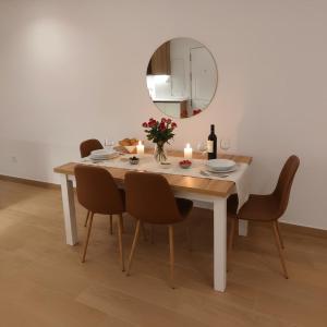 a dining room table with candles and a mirror at New! Marbella Apartamento junto a la Playa y Casco Histórico - 2 Habitaciones Dobles - 80 m2 in Marbella