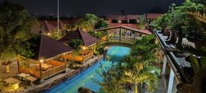 an overhead view of a house with a bridge over a pool at Griya Yodesiya Resort Semarang in Karangjati
