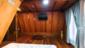 a room with a bed and a tv on the wall at Griya Yodesiya Resort Semarang in Karangjati
