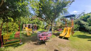 a park with a playground with a slide at Griya Yodesiya Resort Semarang in Karangjati