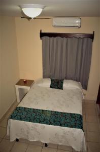 Postel nebo postele na pokoji v ubytování Apart Hotel Express