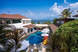 an aerial view of a resort with a swimming pool and umbrellas at Dream Divers Resort in Gili Trawangan