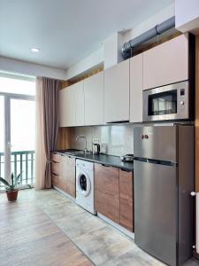 a kitchen with a washer and dryer in it at Airport Hotel Apartments in Tbilisi City
