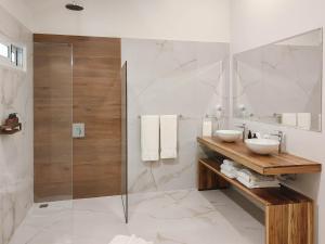 a bathroom with two sinks and a glass shower at Cloud Forest Lodge in Monteverde Costa Rica