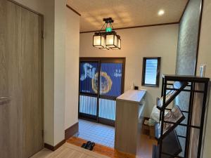 a hallway with a door and a staircase with a window at 凪 nagi Awaji in Awaji