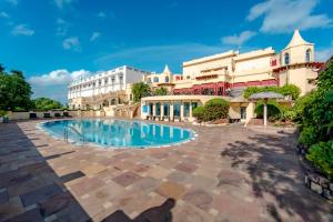 a swimming pool in front of a building at Noor-Us-Sabah Palace in Bhopal