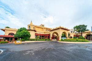 an empty street in front of a large building at Noor-Us-Sabah Palace in Bhopal
