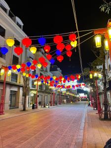 an empty street at night with colorful umbrellas at Hola Hotels Móng Cái in San Cap
