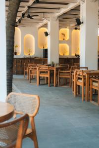 a dining room with wooden tables and chairs at Lay Day Gili T in Gili Trawangan