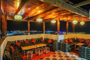 a bar with couches and a view of the city at The Palm Surfhouse in Tamraght Ouzdar
