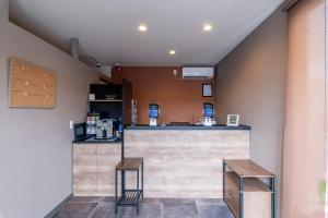 a bar in a restaurant with two stools at HOTEL R9 The Yard Hanazonointer in Imaichi