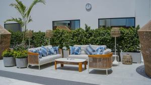 a patio with a couch and chairs and a table at Karachi Marriott Hotel in Karachi