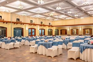 a large banquet hall with blue and white tables and chairs at Noor-Us-Sabah Palace in Bhopal +82 photos