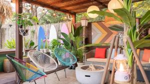 a patio with chairs and surfboards painted on the wall at Green Soochaehwa Pension Yangyang in Yangyang