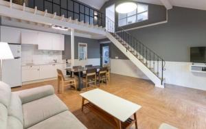 a living room with a couch and a table at Green Soochaehwa Pension Yangyang in Yangyang