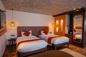 a hotel room with two beds and a mirror at Dhulikhel Mountain Resort in Dhulikhel +106 photos