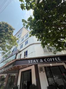 a building with a sign that reads stay and coffee at An Phú Stay & Coffee in Cửa Lô