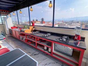 a kitchen counter with a view of a city at Habitación individual con baño privado a 3 Min del Estadio Azteca-Banorte y muy cerca de zona de hospitales in Mexico City