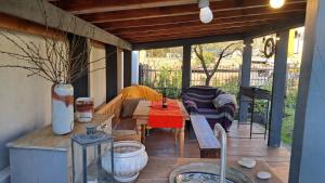 a patio with a table and chairs on a porch at Flat in cottage close to the centre parking, WiFi, BBQ in Lviv