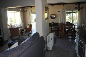 een woonkamer met een bank en een eetkamer bij 37 Valley View Cottage in Underberg