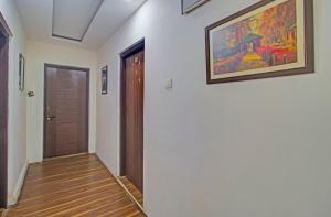 a hallway with a painting on the wall and a door at Collection O NIT Srinagar Formerly Main Street Inn in Srinagar +35 photos