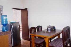 a dining room with a table and a refrigerator at Kattel Homestay and Apartments in Bālāju