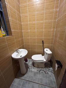 a bathroom with a toilet and a sink at Ikamba Residence in Rwamagana +14 photos