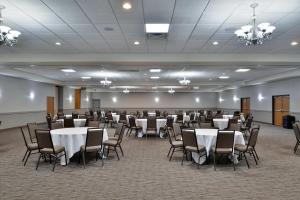 a banquet hall with white tables and chairs at Comfort Inn & Suites Madison North in De Forest +62 photos
