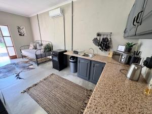 a kitchen with a sink and a counter top at Stylish One Bedroom Garden Suite in Polokwane