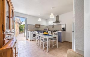 a kitchen with a table and chairs in a kitchen at Puresa in Artá
