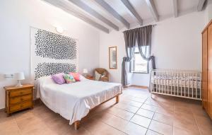 a bedroom with a bed and a crib in it at Puresa in Artá