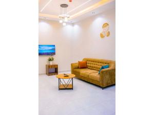 a living room with a couch and a table at Residency by Mozette Kigali in Kigali