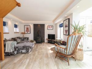 a living room with a bed and a couch at Kiloran in Rhosneigr