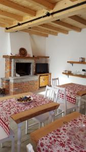 a dining room with two tables and a fireplace at B&B CA'SUANA in Lanzo dʼIntelvi