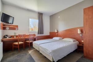 a hotel room with a bed and a table and chairs at CIT'HOTEL Armony Hotel in Bourg-Achard +114 photos