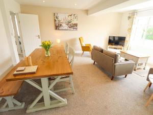 a dining room with a wooden table and chairs at Field View in North Walsham