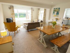 a living room with a table and a couch at Field View in North Walsham