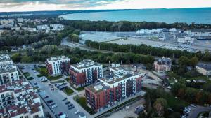 an aerial view of a city with buildings and the water at Porto in Gdańsk