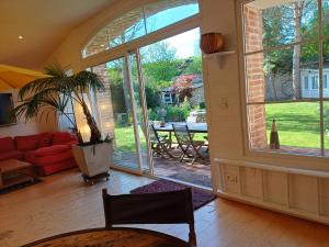 a living room with a red couch and a large window at Villa Roma in Montluçon