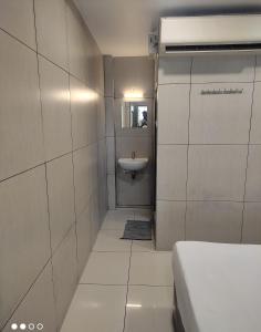 a small bathroom with a sink and a toilet at Abidharpp in Velankanni