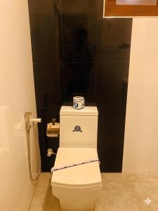 a white toilet with a box on top of it at H M C Leisure Villa Devinuwara in Dondra North