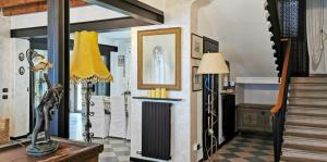 a living room with a staircase and a painting on the wall at Manor Villa Among Veneto's Orchards in Castelbaldo +26 photos