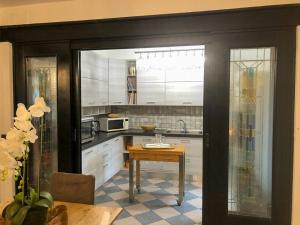 a kitchen with white cabinets and a table at Manor Villa Among Veneto's Orchards in Castelbaldo