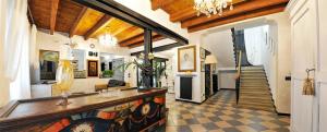 a living room with a chandelier and a hallway at Manor Villa Among Veneto's Orchards in Castelbaldo