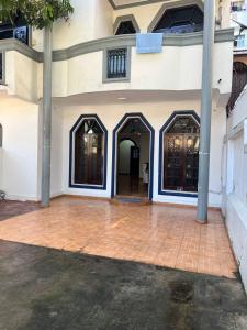 a building with two doors and a brick floor at Johasham Villa in Colombo