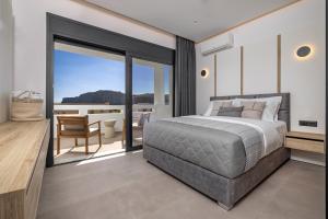 a bedroom with a large bed and a balcony at Luxury Villa Amani Retreat in Lindos +33 photos