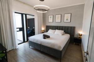 a bedroom with a large bed and a large window at צימר אדל - Zimmer Adel in Yavneʼel +38 photos
