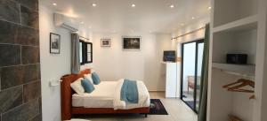 a bedroom with a bed with blue pillows at Paradise City Break in Saint-Pierre +63 photos